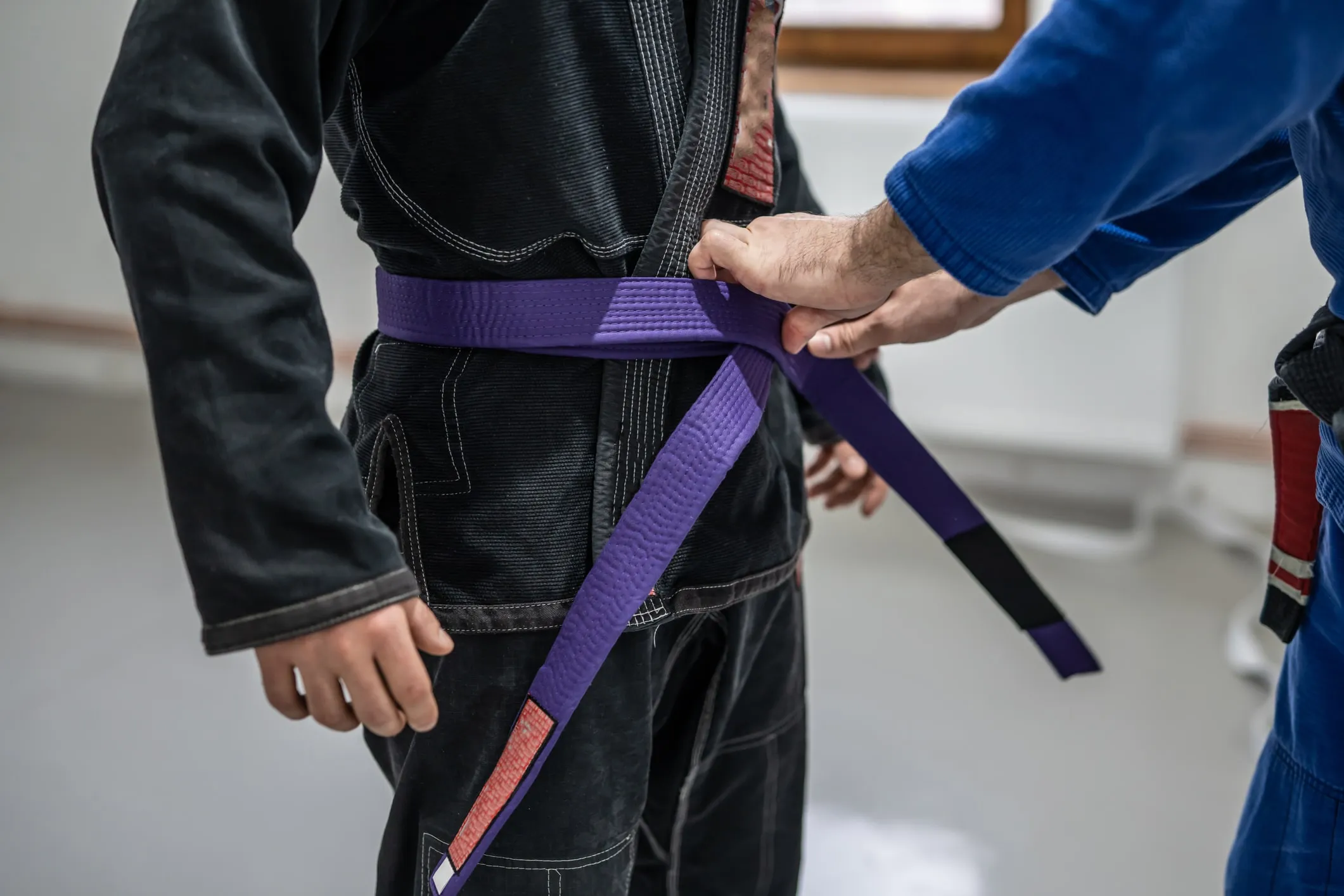 A BJJ belt tied around a gi